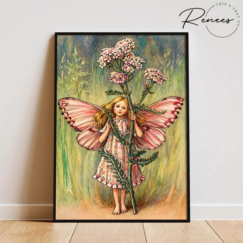 May include: A framed print featuring a young girl with butterfly wings, holding a tall flower with pink blossoms. The girl wears a pink and white dress. The artwork has a vintage, whimsical style, with the text "This & That Co" in the upper right corner.