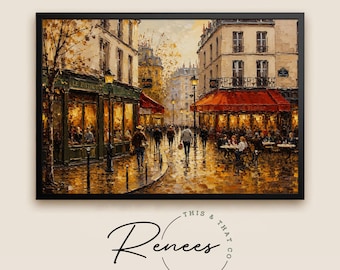 May include: A framed oil painting print depicting a Parisian street scene with a bistro on the left and a cafe with a red awning on the right. People walk along the wet pavement under street lamps. The text This & That Co. Renees is below.