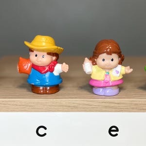 May include: Four colorful Little People figures. A construction worker in an orange hard hat, a cowboy with a yellow hat, a girl in a yellow jacket, and a boy holding a green frog. They are arranged on a wooden shelf.