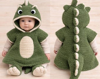 May include: A crochet dinosaur costume featuring a dark green hooded poncho with a cream-colored belly patch. The hood includes large white and black eyes and a row of cream-colored spikes along the back that extend down to a pointed tail.