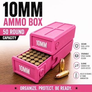 May include: A bright pink 10mm ammo box with a 50 round capacity. The box features a sliding drawer design with the text 10MM printed on the front. Two brass-colored 10mm cartridges are placed next to the box. The text 10MM AMMO BOX 50 ROUND CAPACITY and ORGANIZE. PROTECT. BE READY. are visible.