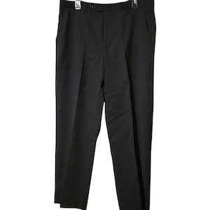 May include: Black dress pants with a button closure, belt loops, and side pockets. The pants are hanging on a black hanger. The pants are made of a smooth, solid fabric.
