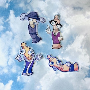 May include: Four cartoon stickers depicting chess piece characters with large eyes. One wears a fedora and suit, another a blazer and glasses, a third a royal robe, and the last is lounging in shorts.