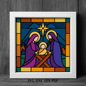 May include: A square white frame containing a stained glass style illustration of a nativity scene. The image features three figures in purple and blue robes around a central manger, a yellow star above, and silhouettes of animals in the background.