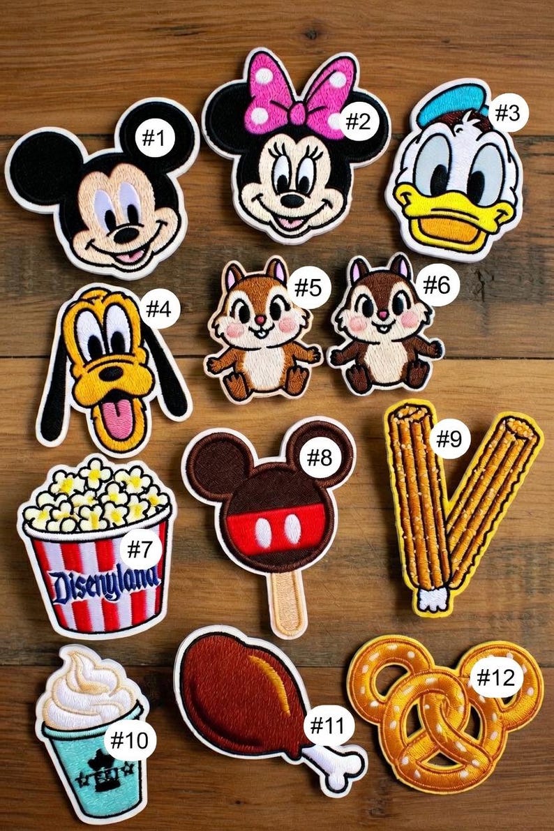 May include: Embroidered patches featuring Disney characters and park-themed food items. Includes Mickey Mouse, Minnie Mouse, Donald Duck, Pluto, Chip and Dale, popcorn, ice cream, a Mickey ice cream bar, a turkey leg, and a Mickey pretzel.