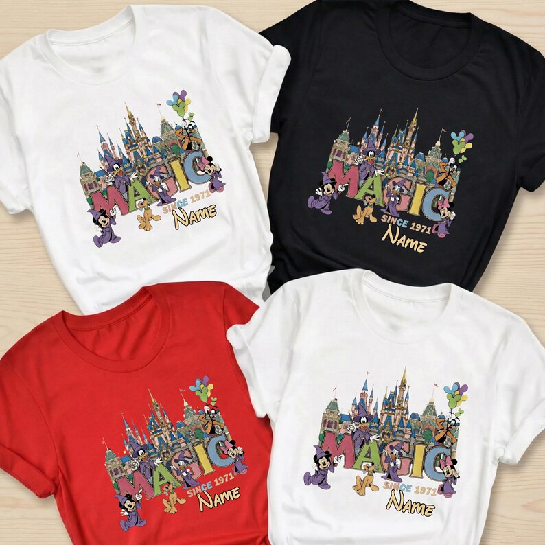 May include: Four t-shirts in white, black, and red, featuring a colorful graphic design. The design includes the word "MAGIC" with a castle illustration, Mickey Mouse, and the text "SINCE 1971" and "Name".