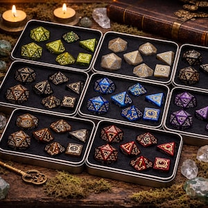 May include: A selection of polyhedral dice sets in metal tins. The dice are in various colours, including green, gold, blue, and red, with metallic accents. The dice are arranged in black trays, with a key and candles in the background.