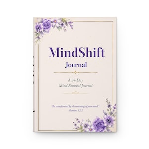 May include: A hardcover journal titled "MindShift Journal" with a cream-colored cover. The cover features the title in purple script, floral accents, and the text "A 30-Day Mind Renewal Journal." The quote "Be transformed by the renewing of your mind." is also included.