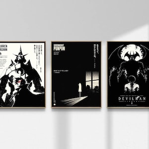 May include: Three framed black and white anime art prints. The prints feature stylized illustrations with Japanese text. The first print says "GURREN LAGANN". The second print says "GOODNIGHT PUNPUN". The third print says "DEVILMAN".