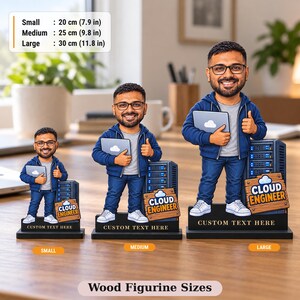 Three wood figurine sizes of the custom cloud engineer caricature side by side: small 20 cm (7.9 in), medium 25 cm (9.8 in) and large 30 cm (11.8 in), each on a flat black base.