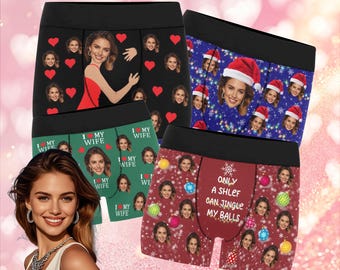 Könnte beinhalten: Vier Boxershorts mit individuellen Gesichtern. Designs umfassen ein schwarzes Paar mit roten Herzen, ein blaues Paar mit Weihnachtsmützen, ein grünes Paar mit dem Text "I MY WIFE" und ein rotes Paar mit Weihnachtsschmuck und Text.
