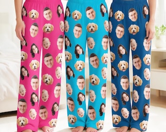 May include: Three pairs of lounge pants in bright pink, light blue, and dark blue, each featuring an all-over repeating pattern of printed faces of a man, a woman, a baby, and a small fluffy dog, with elastic waistbands.