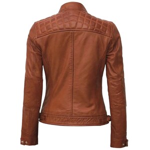 May include: A brown leather jacket with a quilted shoulder design. The jacket has a classic collar, long sleeves, and a fitted silhouette. The back view shows the tailored fit and details like the buttoned cuffs and waist belt.