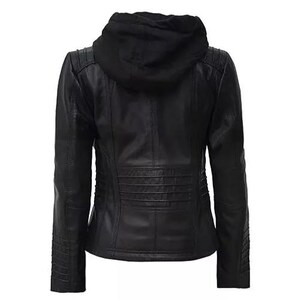 May include: A black leather jacket with a detachable hood. The jacket features quilted detailing on the shoulders and lower back. The sleeves have a ribbed design near the wrists. The jacket is shown from the back.
