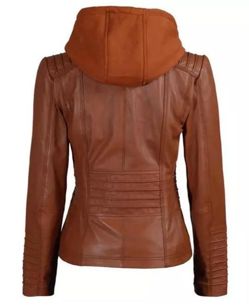 May include: A brown leather jacket with a hood. The jacket has a fitted silhouette with a series of horizontal pleats across the lower back. The sleeves have a ribbed design on the lower portion. The hood is a darker shade of brown.