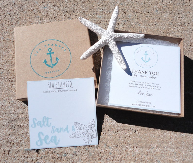 May include: A product presentation featuring a white starfish, a brown box with a teal anchor logo, and a white card with the text "Sea Stamped Designs". Another card reads "Salt, Sand & Sea". A thank you card is also visible.