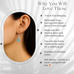 May include: Minimalist drop earrings with a bezel, featuring a light blue cultured sea glass stone. The earrings are approximately 1 inch in length and made with 925 sterling silver. The image also includes text.
