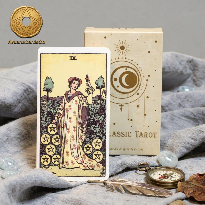Classic Rider Waite tarot cards deck with Nine of Pentacles card, elegant tarot box, vintage spiritual tarot setup with compass and crystals