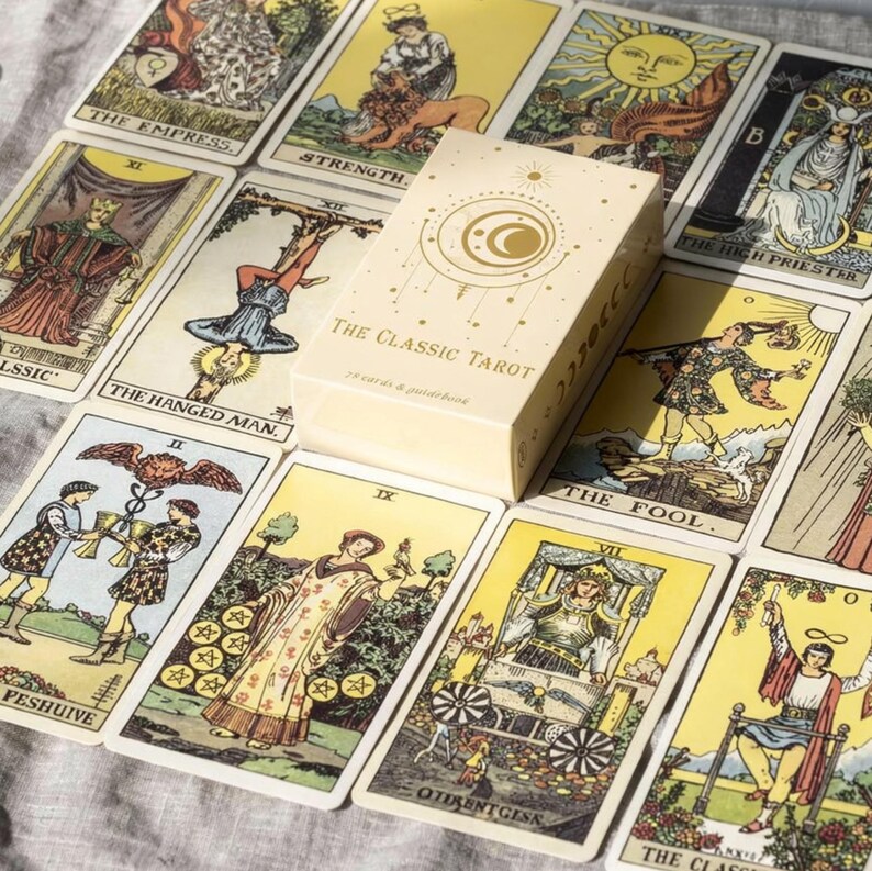 Classic Tarot deck box placed on full Rider Waite tarot card spread featuring Major Arcana cards