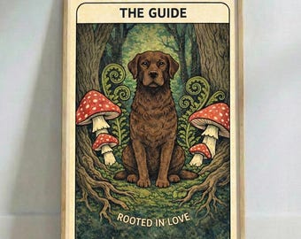 May include: A framed art print depicting a brown dog in a forest, with red and white mushrooms. The text "THE GUIDE" is at the top, and "ROOTED IN LOVE" at the bottom. The artwork has a vintage style, with a wooden frame.