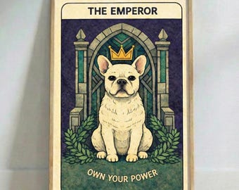 May include: Framed tarot card print depicting a cream-coloured French Bulldog wearing a gold crown, labelled "THE EMPEROR." The artwork includes a green archway, laurel leaves, and the text "OWN YOUR POWER" on a wooden floor.