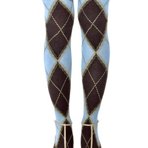 May include: Light blue and brown argyle patterned tights. The tights feature a classic diamond design with a light blue background and brown diamonds. The tights are worn with beige heels with a strap.