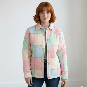 May include: A pastel patchwork jacket in pink, green, blue, and cream. The jacket features a button-up front and a collar, worn over a grey top and blue jeans. The visible stitching enhances the quilted design of the garment.