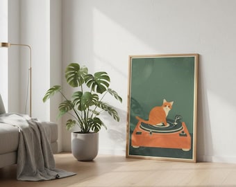May include: A framed art print featuring an orange cat sitting on a vintage orange record player. The background is a dark green color. The print is displayed in a room with a monstera plant and a gray sofa.