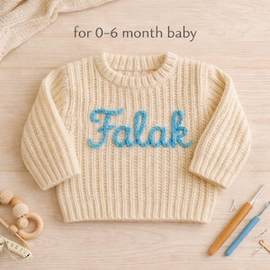 May include: A white ceramic mug with a black handle and the text "But First, Coffee" in a bold, black font. The mug is set against a blurred background, highlighting its clean design.