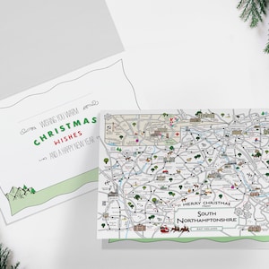 May include: A Christmas card featuring a map of South Northamptonshire, England. The card has a green and white color scheme and includes the text "Merry Christmas from South Northamptonshire".