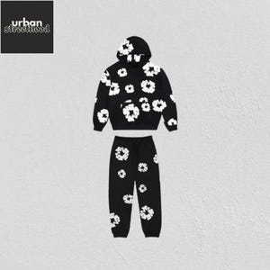 May include: Black two-piece sweatsuit set with a white floral pattern. The set includes a hooded sweatshirt and matching sweatpants. The sweatshirt has a front pocket and the text "urban streetthood" in the upper left corner.