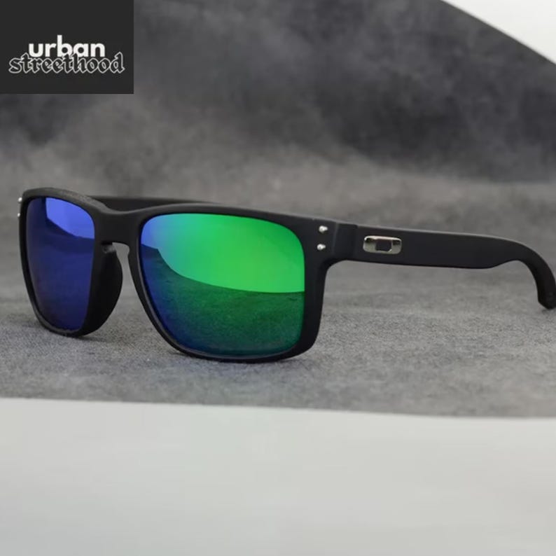 May include: Black sunglasses with green and blue mirrored lenses. The sunglasses have a square frame and the text "urban street hood" in the upper left corner.