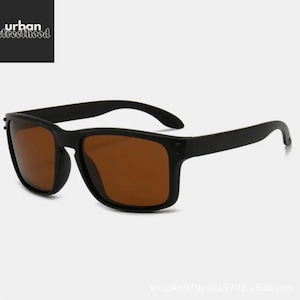 May include: Black sunglasses with brown lenses. The sunglasses have a rectangular frame and curved arms. The text "urban streetfood" is in the upper left corner.