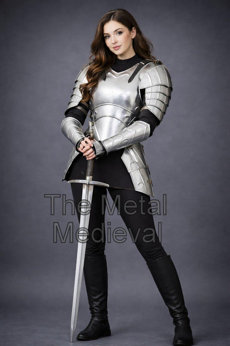 May include: A person wearing polished silver metal armor, including a breastplate, shoulder guards, and arm protection. The person is holding a long silver sword. The text "The Metal Medieval" is visible on the image.