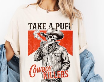 スモーキングスケルトンユニセックス大人用Tシャツ、カウボーイキラーズシャツ、エッジの効いたオルタナティブファッションギフト。面白いスカルグラフィックTシャツ、ヴィンテージウエスタングランジシャツ