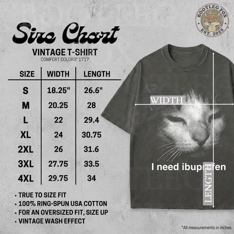 May include: Dark gray vintage t-shirt with a distressed cat face graphic and the text "I need ibuprofen." The shirt features a size chart with measurements in inches. Made of 100% ring-spun USA cotton.