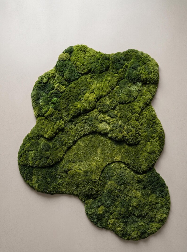 May include: A vibrant green moss rug with an organic, layered design. The rug's irregular shape and varying textures create a natural, textured appearance. The moss is a rich, verdant green, adding a touch of nature to any space.
