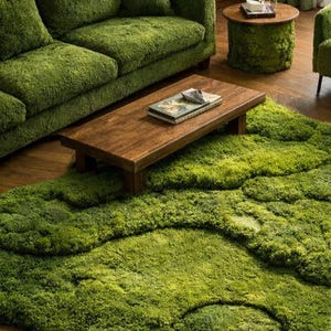 May include: A living room set with a moss-like theme. The set includes a green sofa, armchair, and a round side table. A wooden coffee table sits on a large, green, textured rug. The room has a natural, organic aesthetic.
