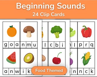 May include: Beginning Sounds 24 Clip Cards Food Themed educational set featuring white rectangular cards with illustrations of fruits and vegetables including an orange, mushroom, broccoli, pepper, watermelon, kiwi, cherry, and corn with letter boxes.