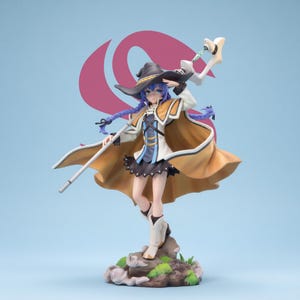 May include: A detailed figurine of a female anime character in a witch-like outfit. She wears a black hat, a tan cape, and a black skirt. The figure holds a staff and stands on a rocky base, set against a light blue background with a pink design.