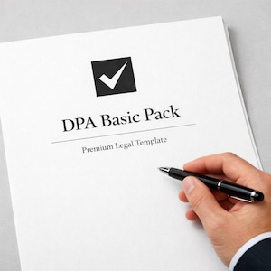 May include: A white sheet of paper with the text "DPA Basic Pack" and "Premium Legal Template" is held by a person. A black pen is held in the person's hand, poised over the paper. A black square with a white tick is at the top.
