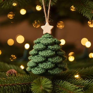 May include: A dark green crocheted Christmas tree ornament featuring a layered, scalloped texture. The ornament is topped with a small, light-coloured wooden star and hangs from a simple, natural-toned jute twine loop for easy display.