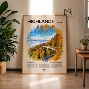 Puede incluir: Una lámina enmarcada titulada HIGHLANDS que presenta un paisaje en estilo acuarela de una carretera de montaña rodeada de follaje otoñal, nubes y un cielo azul. La lámina incluye texto sobre Carolina del Norte, coordenadas y una pequeña bandera de EE. UU.