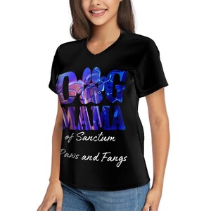 May include: Black V-neck t-shirt with a colorful graphic that reads "O&G Mama" above "of Sanctum Paws and Fangs". The graphic has a paw print and a molecular structure design. The shirt is made of a soft material.