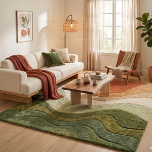 May include: A living room scene featuring a cream-colored sofa with a rust-colored throw blanket and green pillows. A wooden coffee table holds a teapot and cups. A large green and beige rug covers the floor, and a woven lamp hangs in the background.