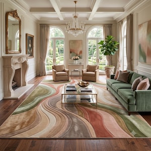 May include: A large area rug featuring a flowing, multi-layered wave pattern in shades of sage green, terracotta, beige, and cream. The rug has a textured, carved appearance with raised sections that create depth across the floor surface.