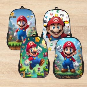 May include: Four black backpacks featuring the character Mario from the Super Mario Bros. video game. Each backpack has a different design, with Mario in various poses against colourful backgrounds. The backpacks have black straps and zips.