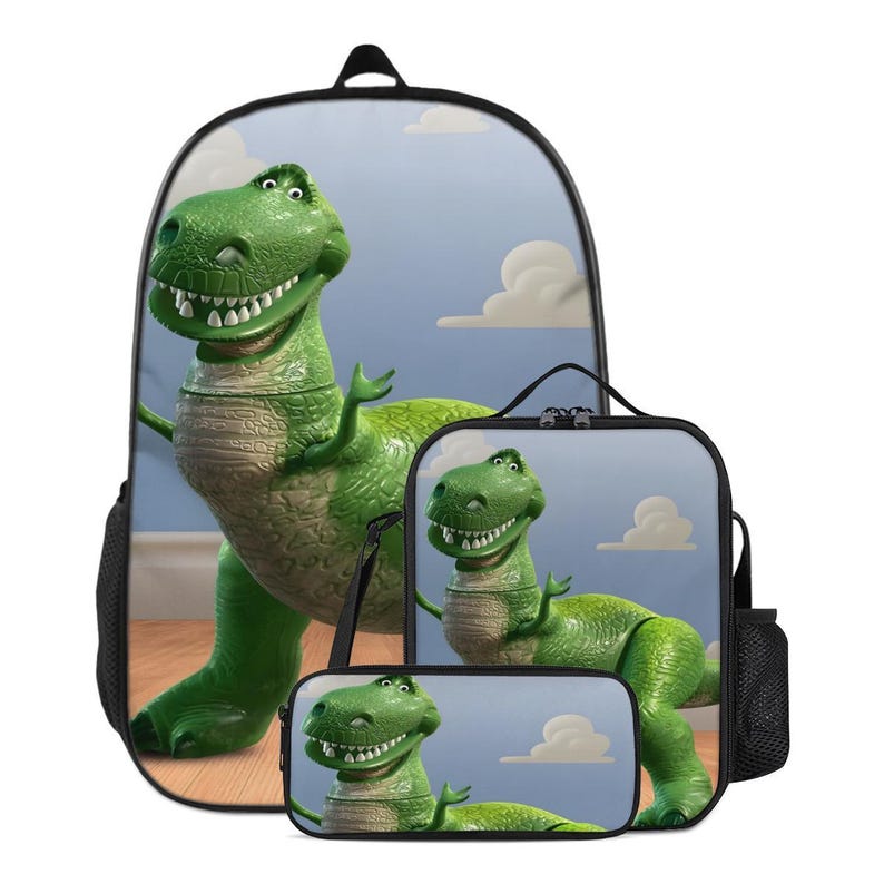 May include: A green dinosaur-themed school set comprising a backpack, lunch bag, and pencil case. The backpack displays a large image of the dinosaur character against a blue sky with clouds. The lunch bag and pencil case share the same design.