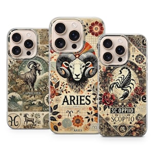 May include: Three phone cases with vintage zodiac designs. The cases feature illustrations of a ram, a goat, and a scorpion, with the words "ARIES", "CAPRICORN", and "SCORPIO" printed on them. The cases have a floral and celestial theme.