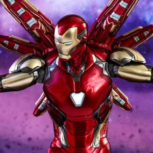 May include: A red and gold Iron Man action figure with outstretched arms and wing-like attachments. The figure has a metallic finish and is set against a purple and blue background, suggesting a space theme.